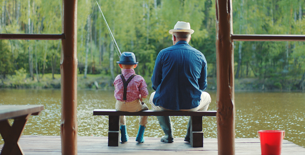 Boy fishing with grandpa