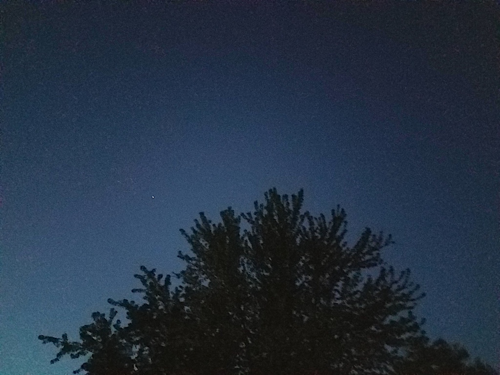 A distant image of the International Space Station in the night sky. 