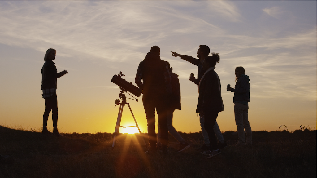 people setting up a telescope for stargazing